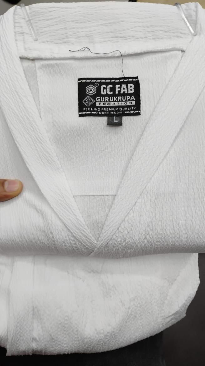 Mens Crinkled Co-Ord Set White displayed, showcasing the texture and label of the garment.